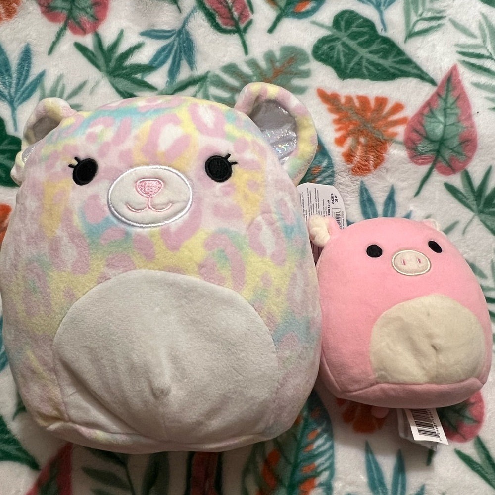 two squishmallows (pig and cheetah)